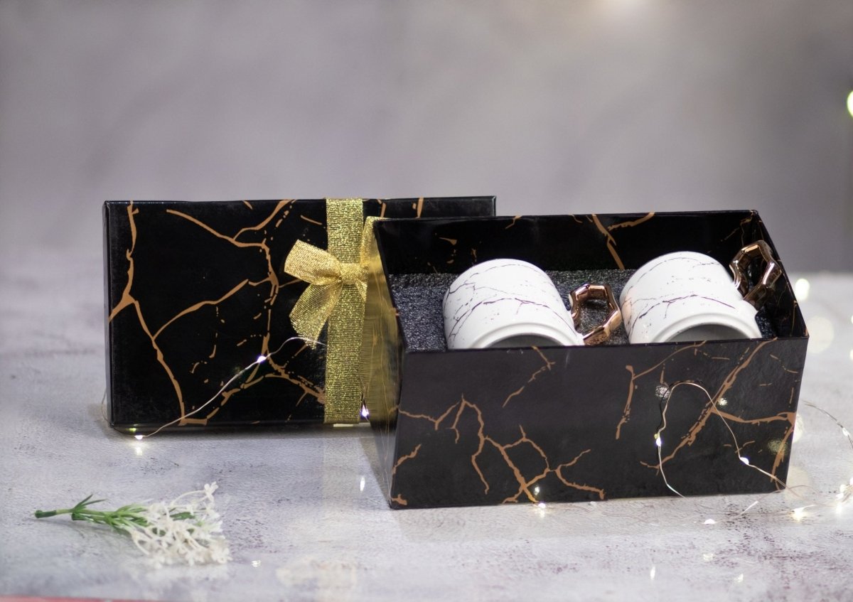 two white cups with plate in a black gift box